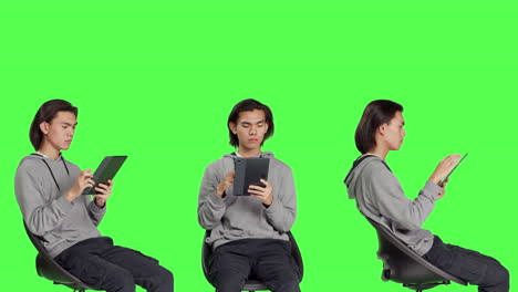 Asian-man-navigating-internet-on-tablet